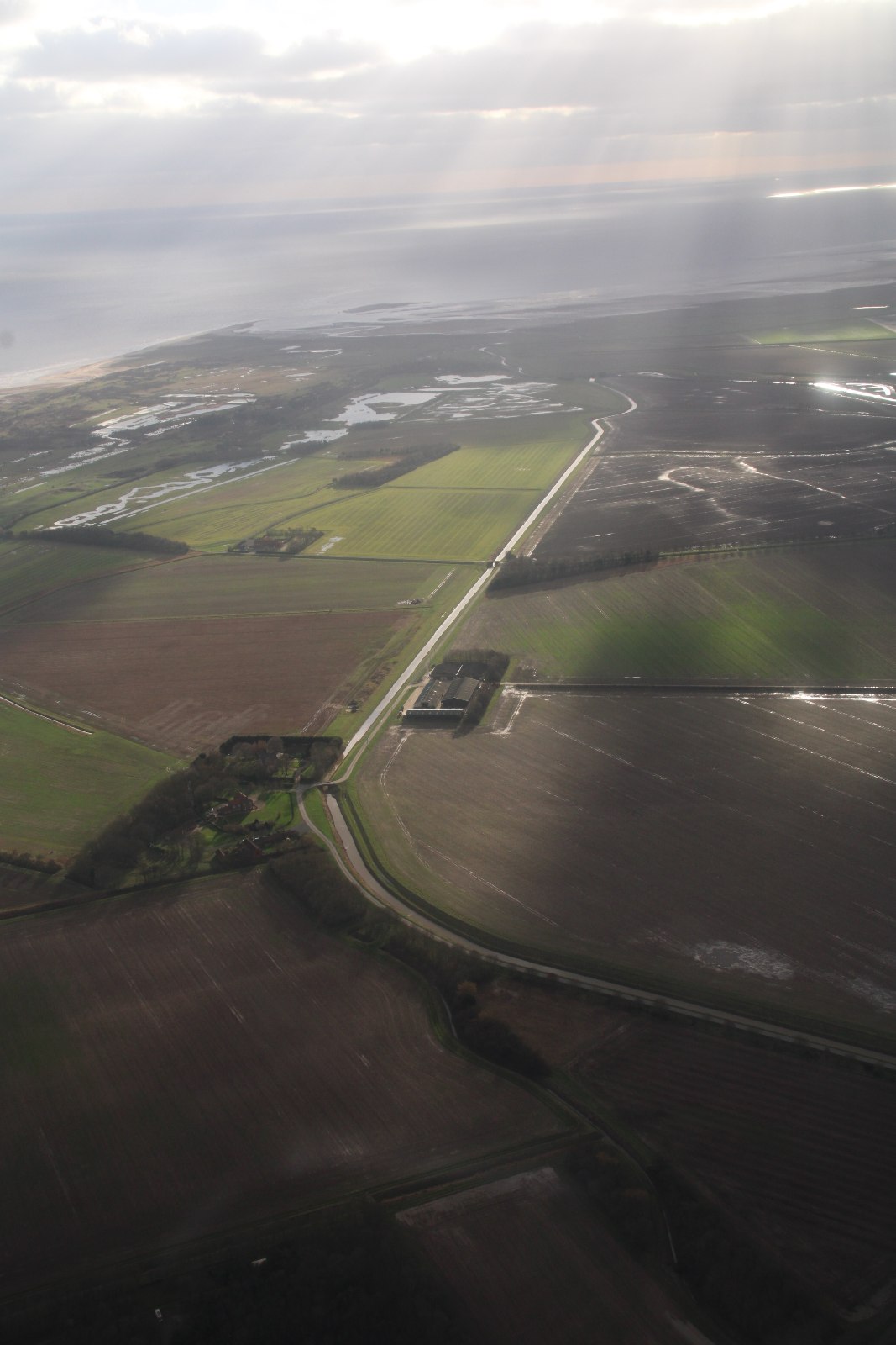 Aerial view south across fields and coastal wetlands towards Gibraltar Point