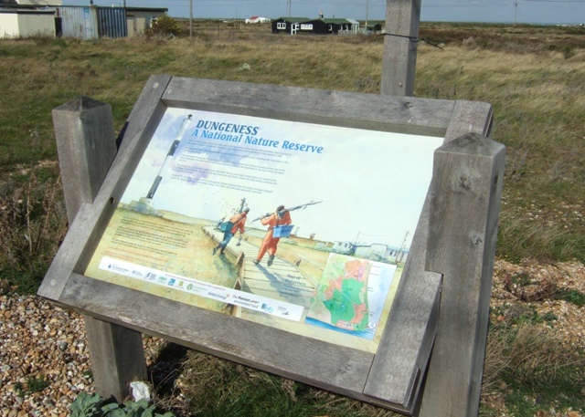 Signs and open shingle landscape in the wider Dungeness National Nature Reserve